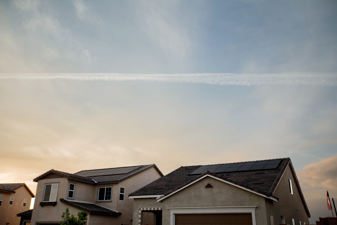 Vivint Solar - Solar Panels on roof of two homes with beautiful sky in background.